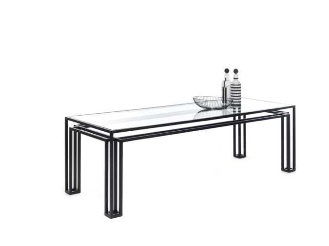 Elegante tavolo Hotline Table minimalista in vetro con struttura metallica, ornato da bottiglie e da un pezzo scultoreo moderno.